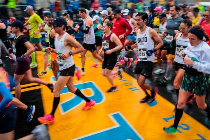 Runners cross the start line of the 2023 Boston Marathon