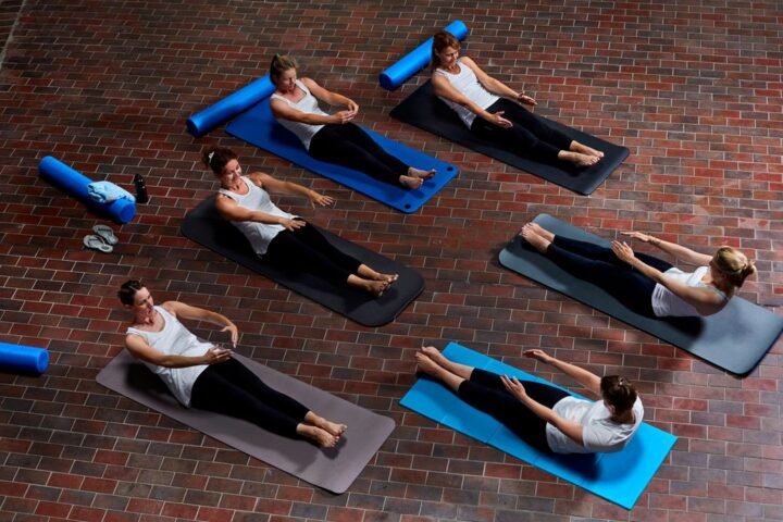 Women performing Pilates roll-up