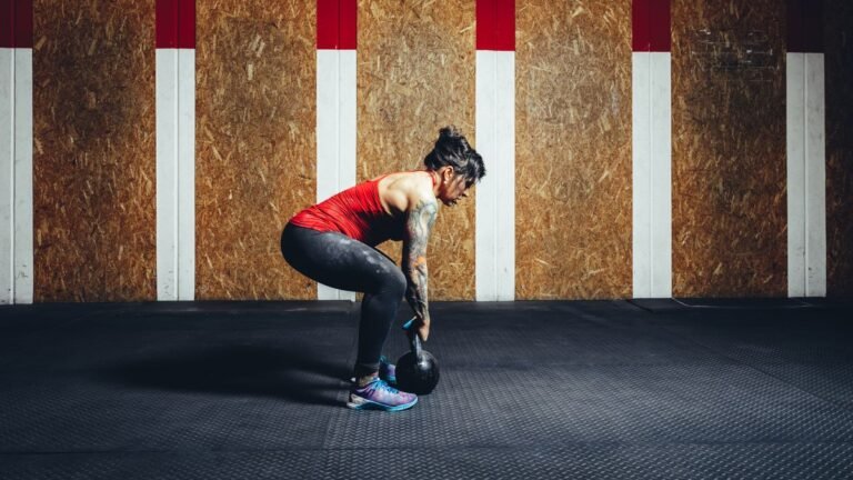 Woman performing deadlift with kettlebell